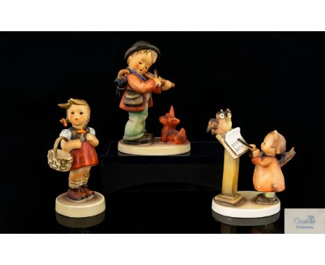 M.J. Hummel Figures ( 3 ) In Total. Comprises 1/ Little Boy Playing Violin - Little Dog In Attendance. 2/ Little Girl with Ba