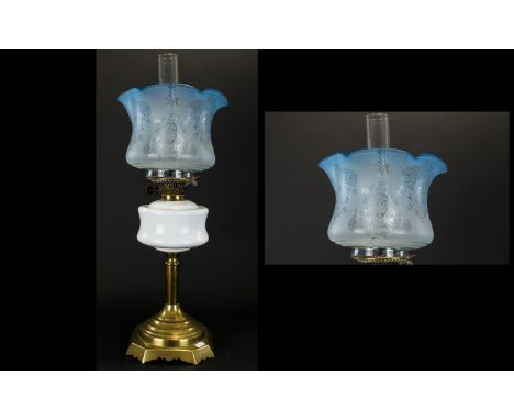 A Late Victorian Oil Lamp Brass support with milk glass reservoir complete with blue glass shade. Overall height, 24 inches