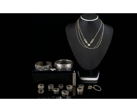 A Collection Of Silver Jewellery Items Comprising hinged bangle with engraved floral decoration, a slave bangle with relief m