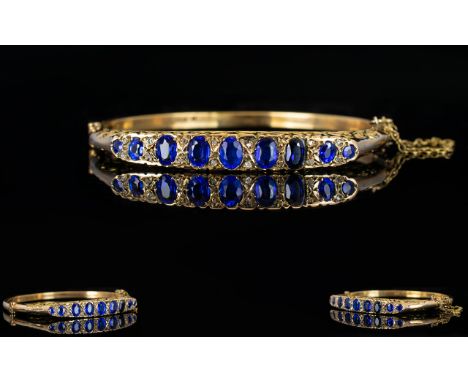 Antique Period Attractive and Pleasing 9ct Gold Sapphire and Diamond Hinged Bangle with attached 9ct gold safety chain, set w