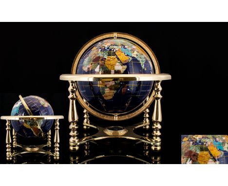 World Globe Set With Lapis And Gemstones On brass lacquered stand with compass. The seas are covered in lapis lazuli and the 