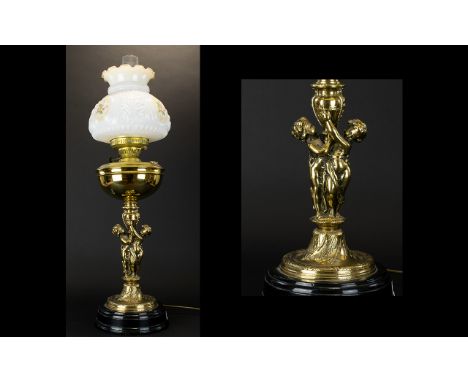 A Victorian Style Converted Oil Lamp Brass figural support with reservoir complete with clear glass chimney and opaline milk 