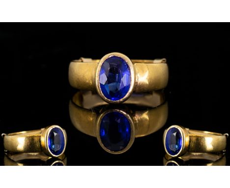 A 22ct Gold And Sapphire Ring Fully hallmarked for 22ct gold the centre set with oval faceted sapphire of wonderful deep colo