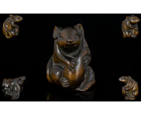 Japanese Superb Quality Signed Carved Boxwood Netsuke in the form of a rat/mouse with long tail holding a large nut circa Mei