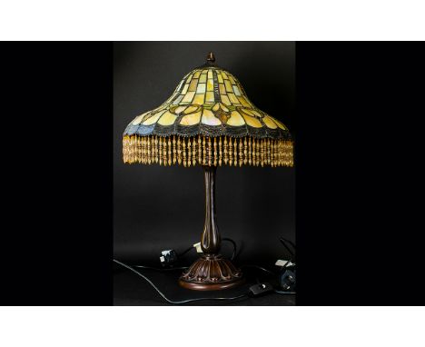 A Reproduction Tiffany Style Table Lamp Hexagonal cast metal base with opalescent geometric design shade and cast metal finia