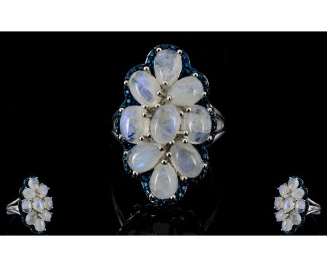Rainbow Moonstone Cluster Ring, a large cluster of nine oval and pear cut rainbow moonstone cabochons, set in an ovoid shape,