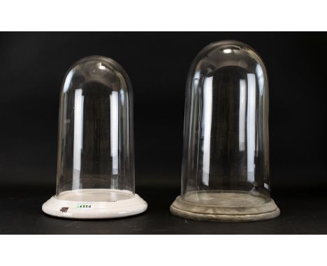 Two Glass Display Domes Each with circular ceramic base and domed glazed cloche. Tallest 15.5 inches, smaller, 14 inches.
