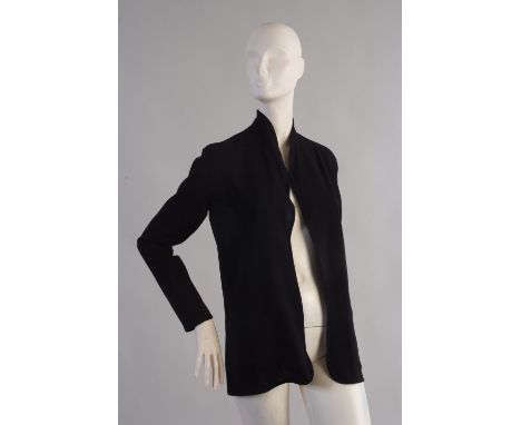 A 1980's 'Christian Dior' black crepe Jacket. The black crepe evening jacket is plain and simple with two front pockets and n