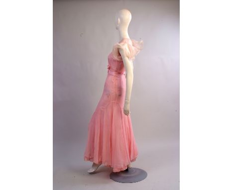 A 1930's Chiffon Tea Dress.  A soft pink chiffon dress bias cut with curved panels to create a pretty lower skirt. The sleeve