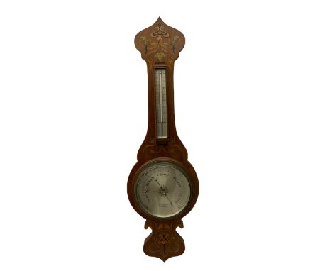 An early 20th century oak cased aneroid barometer in a decorative form with inlay in the arts and crafts style c1920, with a 