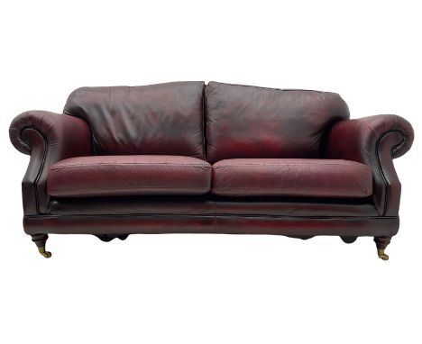 Thomas Lloyd - three seat sofa upholstered in red leather, turned front feet with brass castorsDimensions: Length/Width:&nbsp