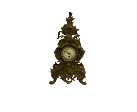 A tall gilt metal mantle clock in a rococo style case c1900, with a French spring driven single train timepiece movement and 