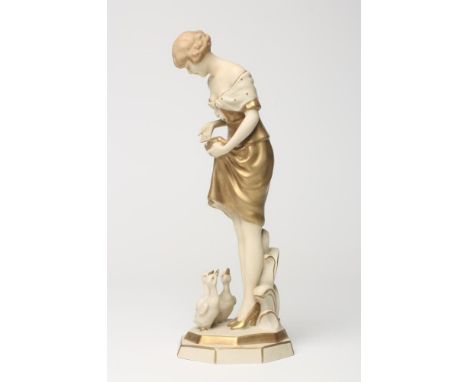 AN ART DECO ROYAL DUX BISQUE PORCELAIN FIGURE OF A YOUNG GIRL with shingled hair, wearing a short off the shoulder dress, thr