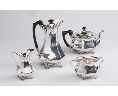 AN EDWARDIAN ARTS AND CRAFTS SILVER FOUR PIECE TEA SERVICE, maker C C Pilling, London 1903, of swept octagonal form, raised u