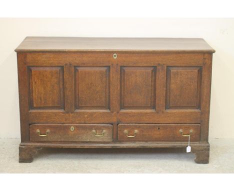 A GEORGIAN OAK PANELLED CHEST, late 18th century, the hinged plank lid opening to interior with small shelf (possibly origina