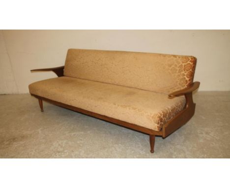 A 1970'S GREAVES & THOMAS TEAK FRAMED SOFA BED, with shaped angled arms and turned tapering legs, now covered in a cream cut 