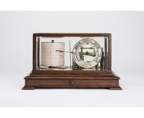 AN OAK CASED BAROGRAPH by Negretti & Zambra, London, with silvered circular scale dial, Rd. No. 428606, the case with bevelle