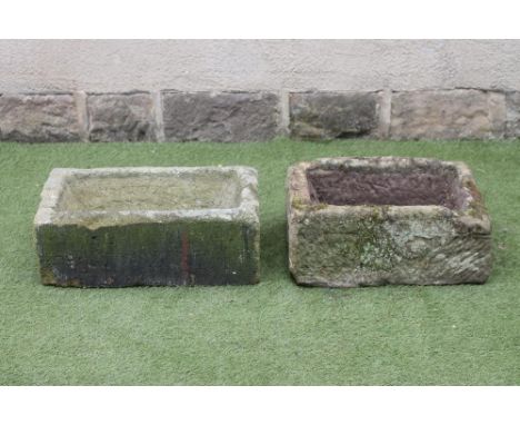 A SANDSTONE TROUGH of oblong form, well cut, 25 1/2" x 15" x 9 1/2", together with another similar, 23" x 16 1/2" x 9 1/2" (2