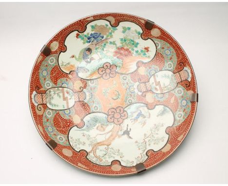 A LARGE JAPANESE IMARI PORCELAIN CHARGER, c.1900, of plain dished circular form, painted in bright enamels with two shaped pa