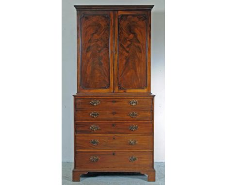 A GEORGIAN MAHOGANY SECRETAIRE CABINET, late 18th century, the cavetto moulded cornice over two doors with applied cut corner