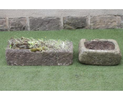 A SANDSTONE TROUGH of narrow oblong form, well cut, 30" x 12 1/2" x 7 1/2", together with another smaller rough hewn oblong t