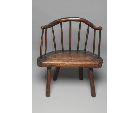 A PRIMITIVE ASH AND ELM STICK BACK ELBOW CHAIR with arched rustic top rail, D shaped seat raised on four chamfered splayed su