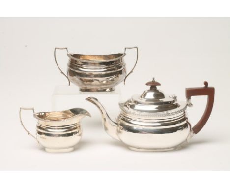 A MATCHED AND COMPOSITE SILVER THREE PIECE TEA SERVICE, teapot maker's mark indistinct, London 1943, milk jug and sugar basin