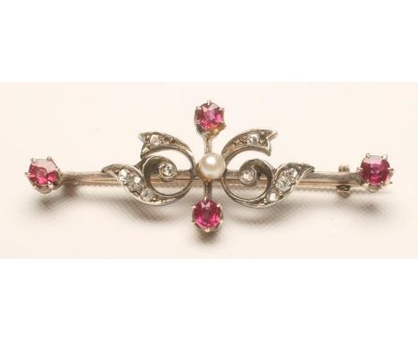 A VICTORIAN BROOCH, the knife edge bar centred by a seed pearl flanked by diamond set scrolls and with a small ruby at each e