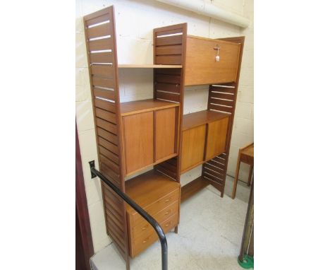 A STAPLES TEAK LADDERAX ROOM UNIT comprising three wooden ladders supporting a cupboard with sliding doors and a desk with fa