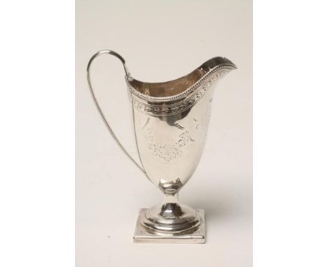 A GEORGE III SILVER PEDESTAL HELMET JUG, maker's mark TS, London 1791, with applied reeded high loop handle and bead rim over