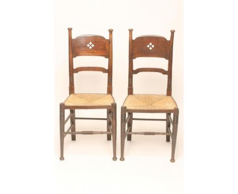A MATCHED PAIR OF WILLIAM BIRCH ARTS AND CRAFTS OAK CHAIRS, the tapering ring turned uprights with cap finials enclosing an a