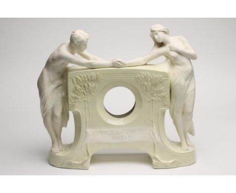 A SECESSIONIST GOLDSCHEIDER EARTHENWARE FIGURAL MANTEL CLOCK CASE, modelled as Adam and Eve holding hands, standing flanking 