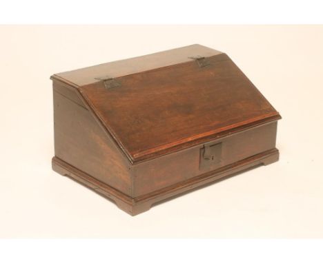 AN OAK BOX DESK, 18th century, the moulded edged lid with iron butterfly hinges opening to interior with three small drawers 
