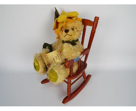 Hermann Flower Bear - a limited edition Daffodil Bear, number 240. The item has a daffodil hat, metal glasses, and is display