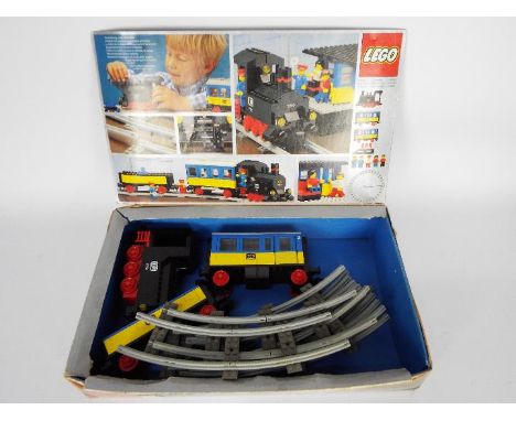 Lego - A boxed vintage 1980s # 7710 train set with loco, carriage, wagon and 8 x curved track sections. The contents appears 