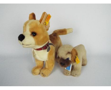 Steiff - two dogs - lot includes two Steiff dogs. One dog has a Steiff collar around its neck. Both items have yellow tags on