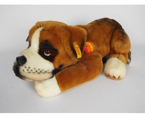 Steiff - one dog - a brown and white original Steiff dog with a yellow tag on its ear. Item appears to be in good condition. 