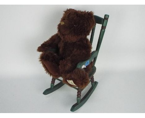 Giorgio Beverly Hills - a 20th anniversary collectors bear, displayed in a green wooden high chair. Item appears to be in goo