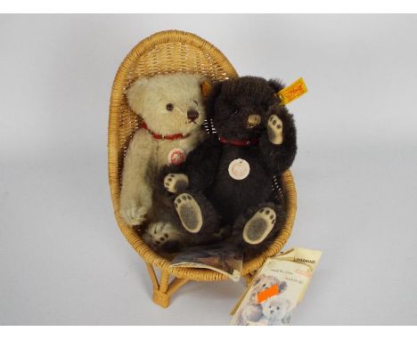 Steiff - Steiff teddy bears - two teddy bears with button and yellow tag in ear and the bears are displayed in a wooden chair
