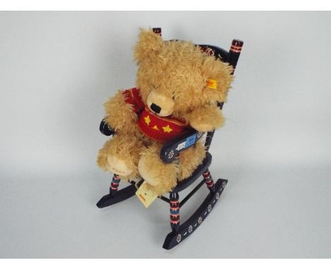 Steiff - a 2007 Steiff teddy bear, displayed in a coloured wooden rocking chair, with button and yellow tag in ear. Item appe