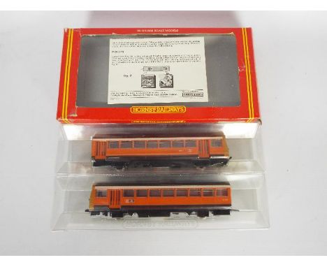 Hornby - A boxed Class 142 Pacer Twin Railbus set in Greater Manchester PTE livery. # R297. The models show light signs of us