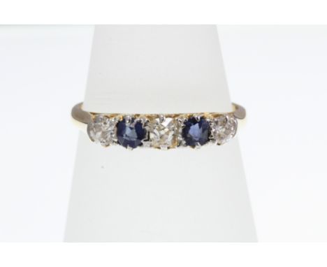 A Sapphire and Diamond 5 stone ring stamped 18ct with engraved decorated setting and old-cut stones, size N.  [VAT included i