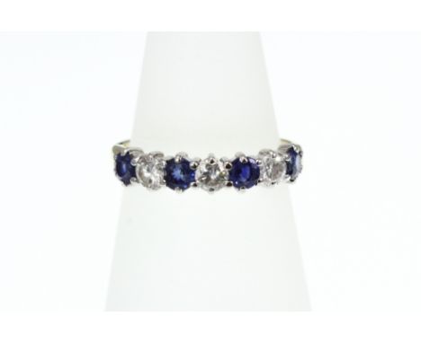 An 18ct H/M sapphire and diamond 7 stone half eternity ring, approx diamond weight 0.50ct, size M-N   [VAT included in hammer