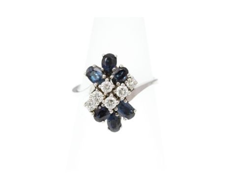 A Sapphire and Diamond cluster ring, the six Diamonds totalling approx 0.30ct, the shank unmarked approx 4.9g, size K