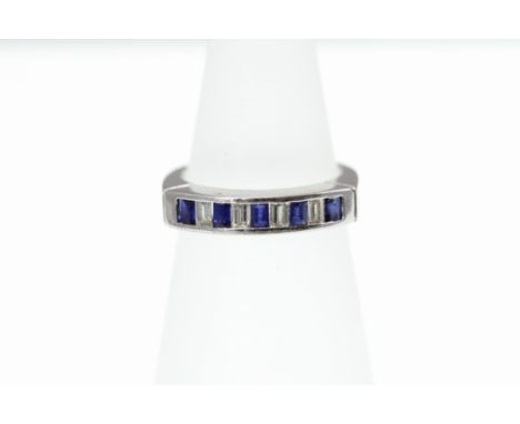 A sapphire and diamond 9 stone baguette half eternity ring stamped 750, size H-I  [VAT included in hammer price on this lot -