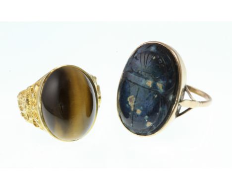 A 9ct H/M gents tigers eye set ring with decorative shoulders, size R and another gents signet ring with a scarab carved ston