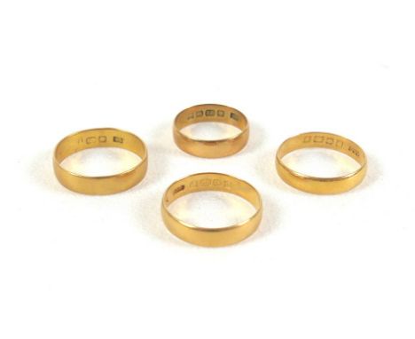 A group of four 22ct yellow gold wedding band rings, 4.1 to 5.0mm wide, sizes K to R, combined weight 12.9g. (4) 
