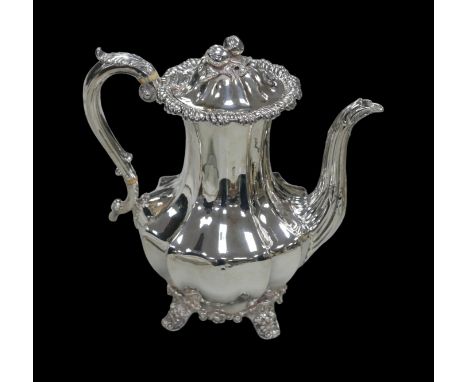 A William IV silver coffee pot, of lobed baluster form, with cast bud and leaf finial, a cast scroll handle with ivory insula