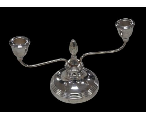 An ERII silver twin-branch candelabrum, with artichoke finial to its centre, raised upon a stepped, circular and weighted bas