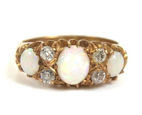 An 18ct yellow gold, diamond and opal ring, set with three oval cabochon-cut opals, largest 6.5 by 5.0mm, and four round cut 